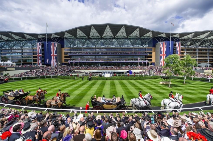 A large crowd of people in a stadium with Ascot Racecourse in the backgroundAI-generated content may be incorrect.